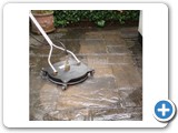 Rotary head power washer on paving slabs